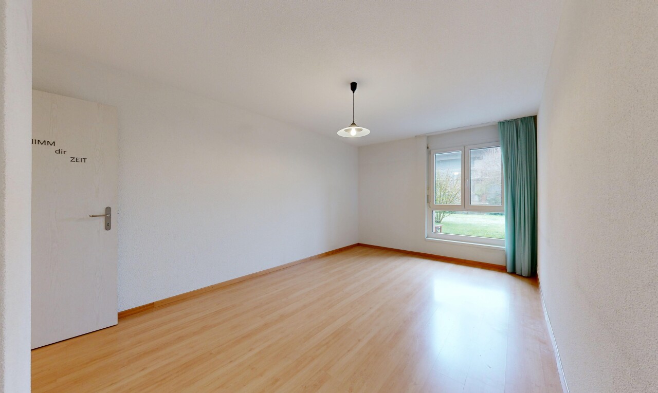 spare room with light wood-style floors and baseboards