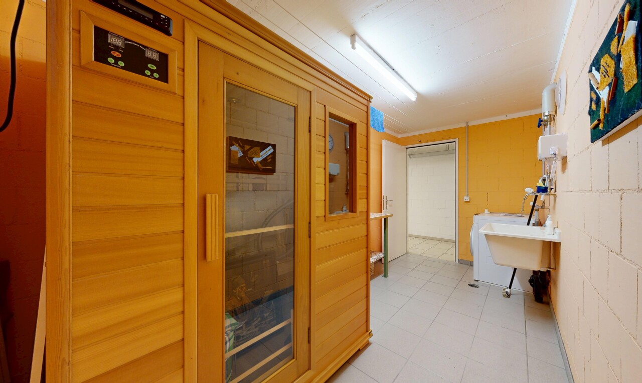 interior space featuring a relaxing sauna, ornamental molding, and washer / dryer