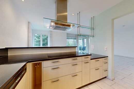 kitchen with island exhaust hood, dishwasher, black electric stovetop, and dark stone counters