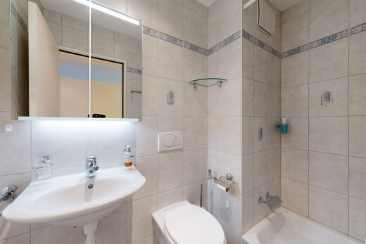 bathroom featuring tile walls and tub / shower combination