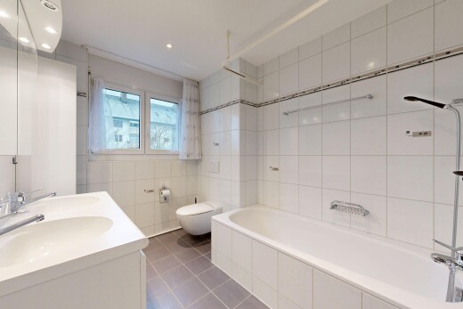 salle de bains avec double vasque, mur en carrelage, tile wall, salle de bain complète, et lumière naturelle