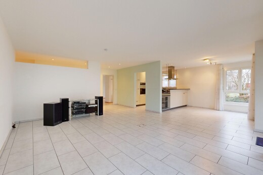 unfurnished living room with baseboards