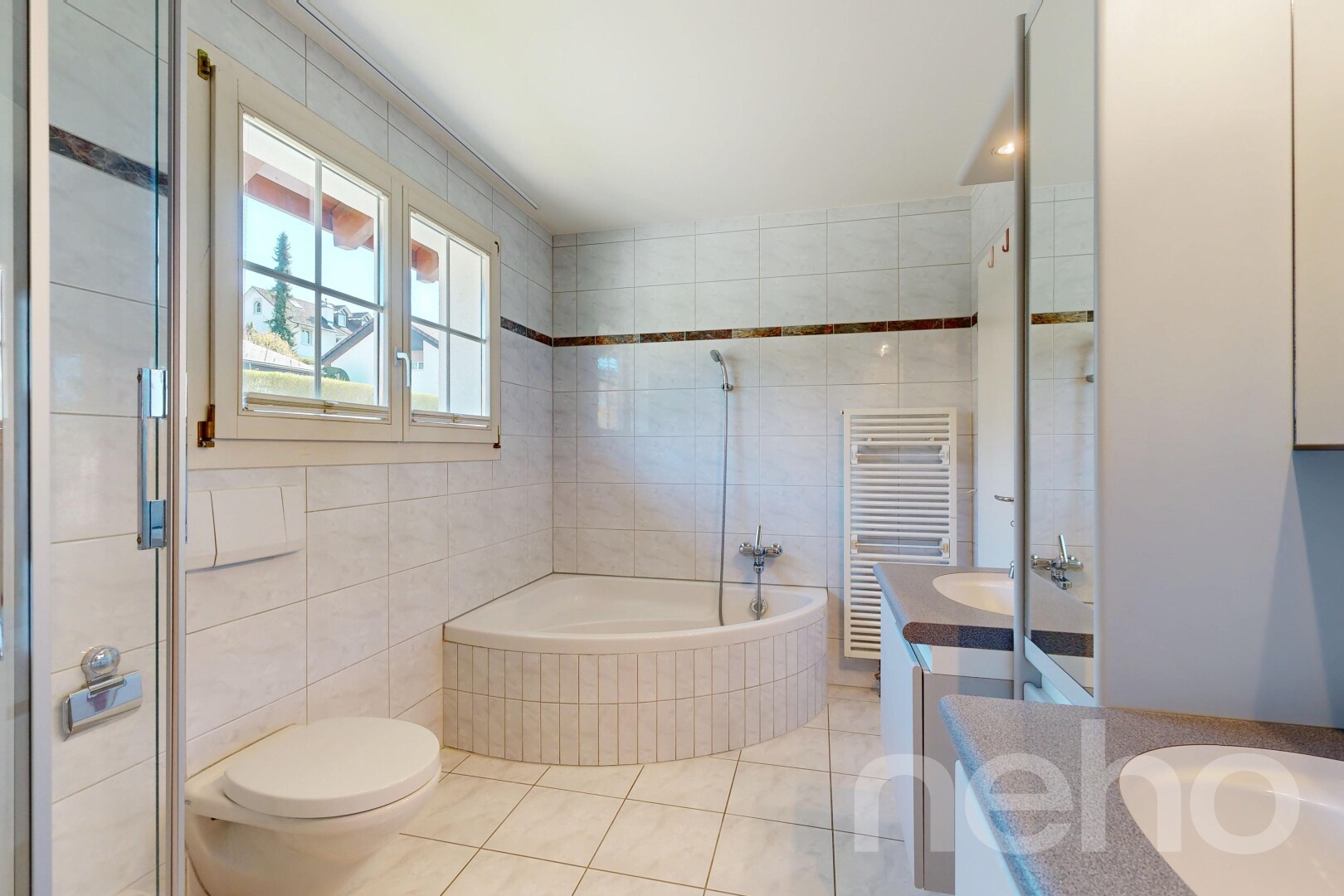 full bathroom featuring a towel warmer, tile walls, radiator heating unit, vanity, and a bath