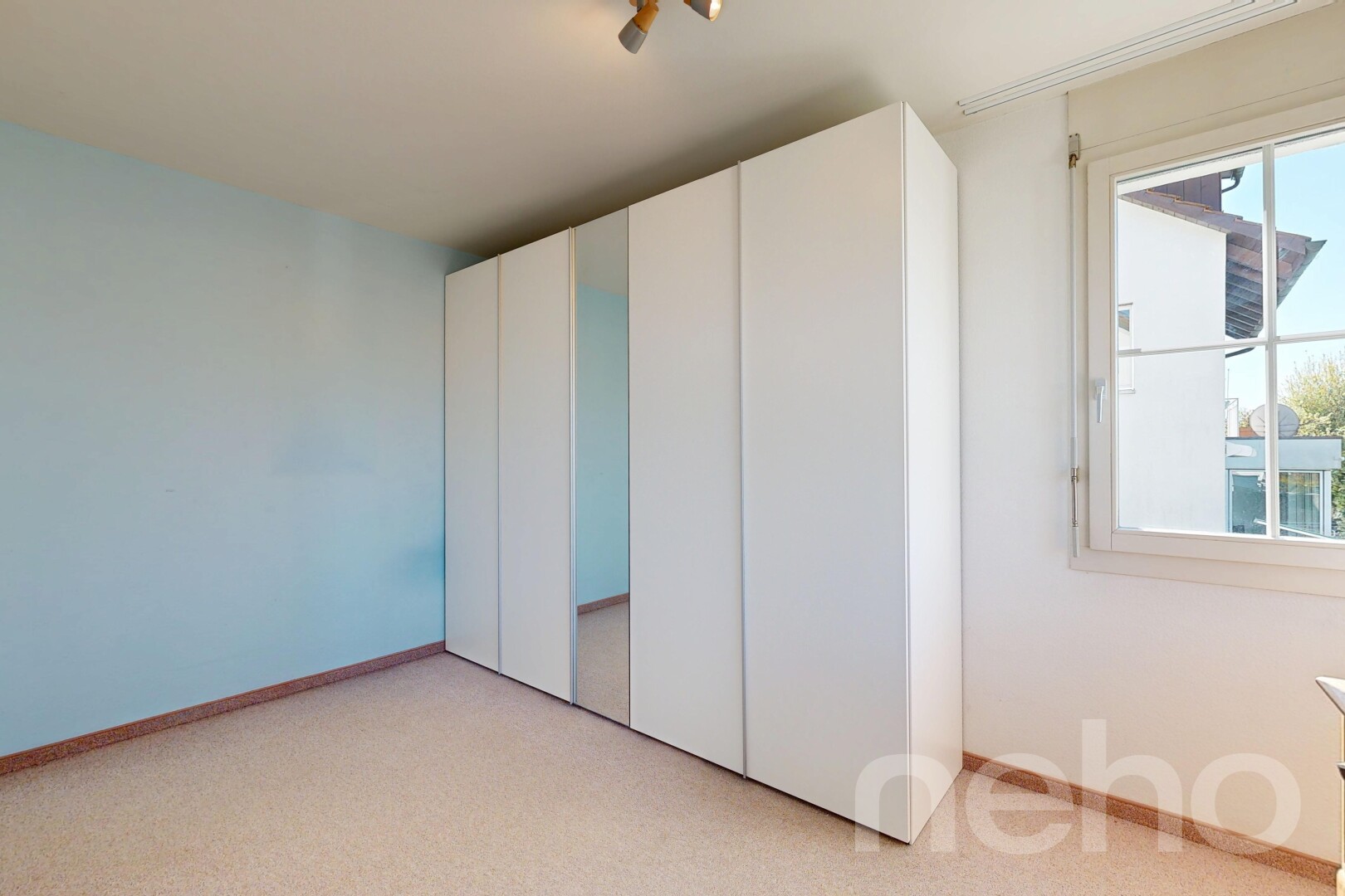 unfurnished room with light carpet and a closet