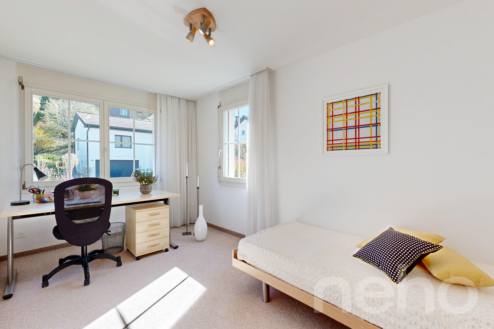 room featuring light colored carpet and a desk