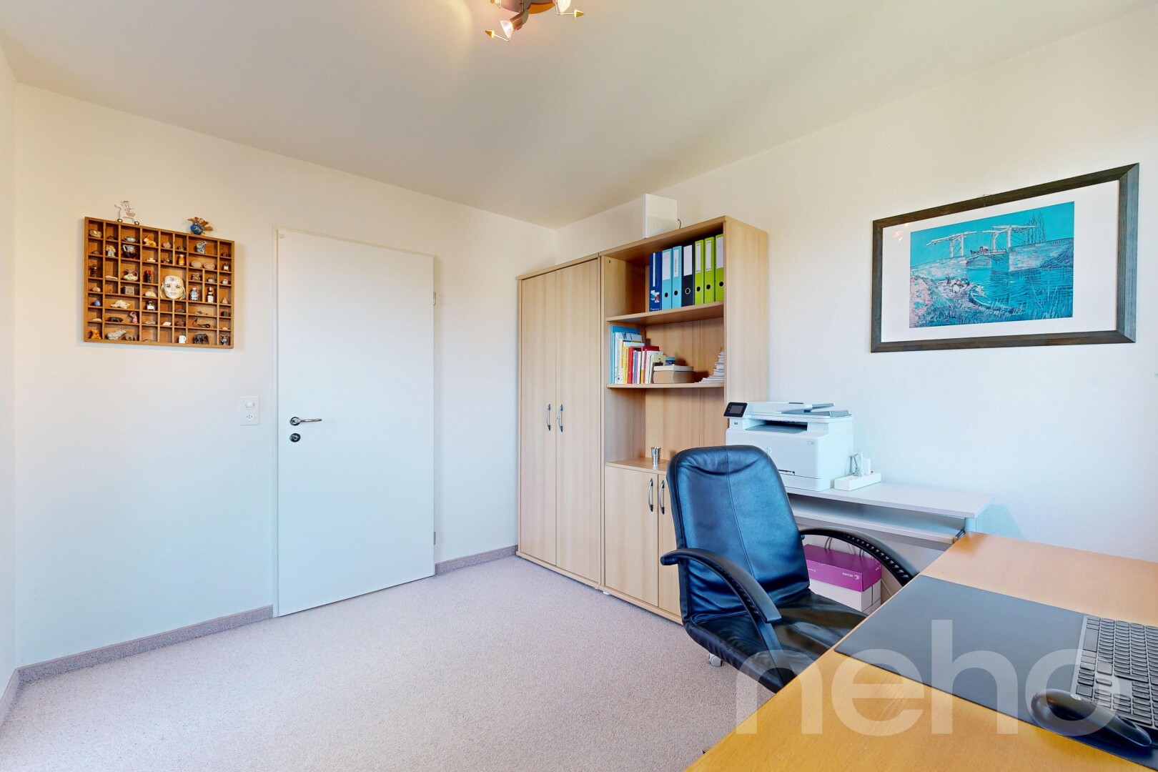 office with light carpet and baseboards
