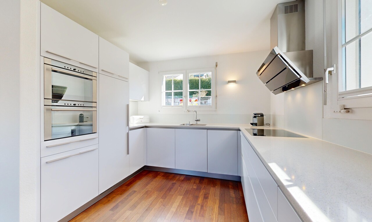 kitchen featuring dark wood finished floors, white cabinetry, light countertops, modern cabinets, and black electric stovetop