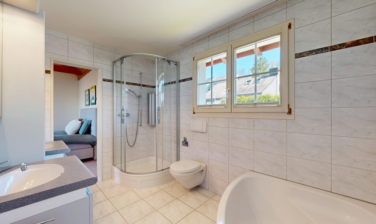 full bathroom with tile walls, vanity, a stall shower, ensuite bathroom, and light tile patterned floors