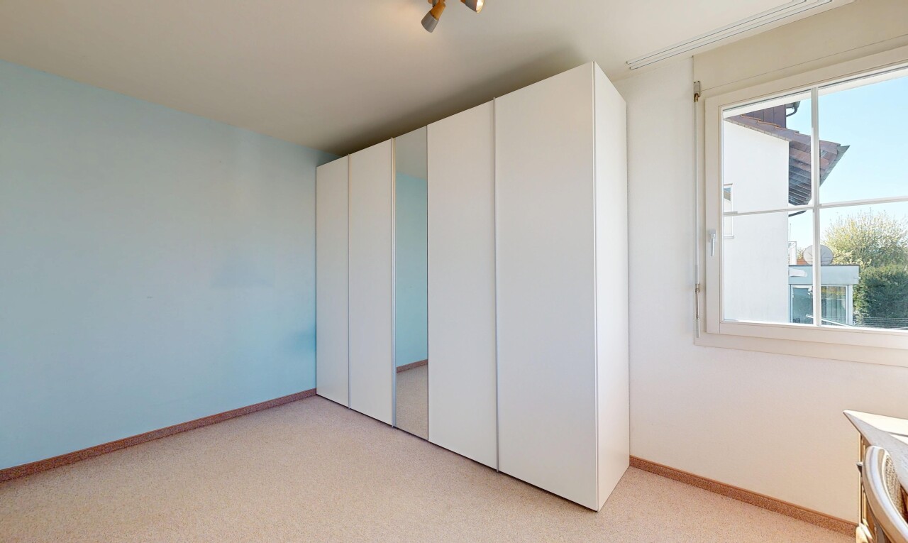 unfurnished room with light carpet and a closet