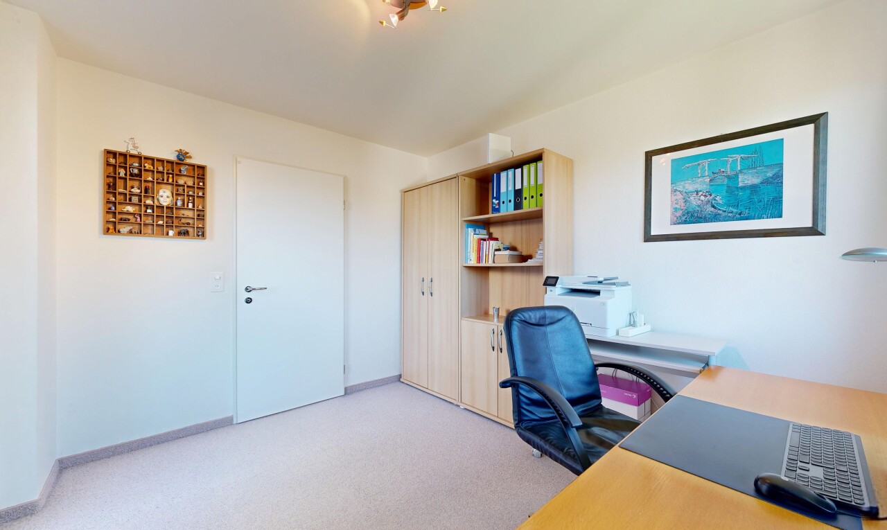 office with light carpet and baseboards