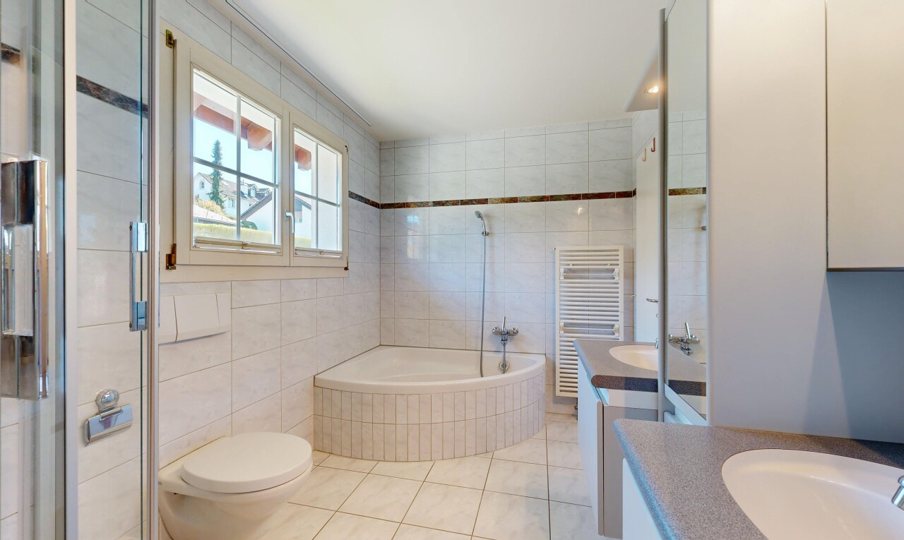 full bathroom featuring a towel warmer, tile walls, radiator heating unit, vanity, and a bath