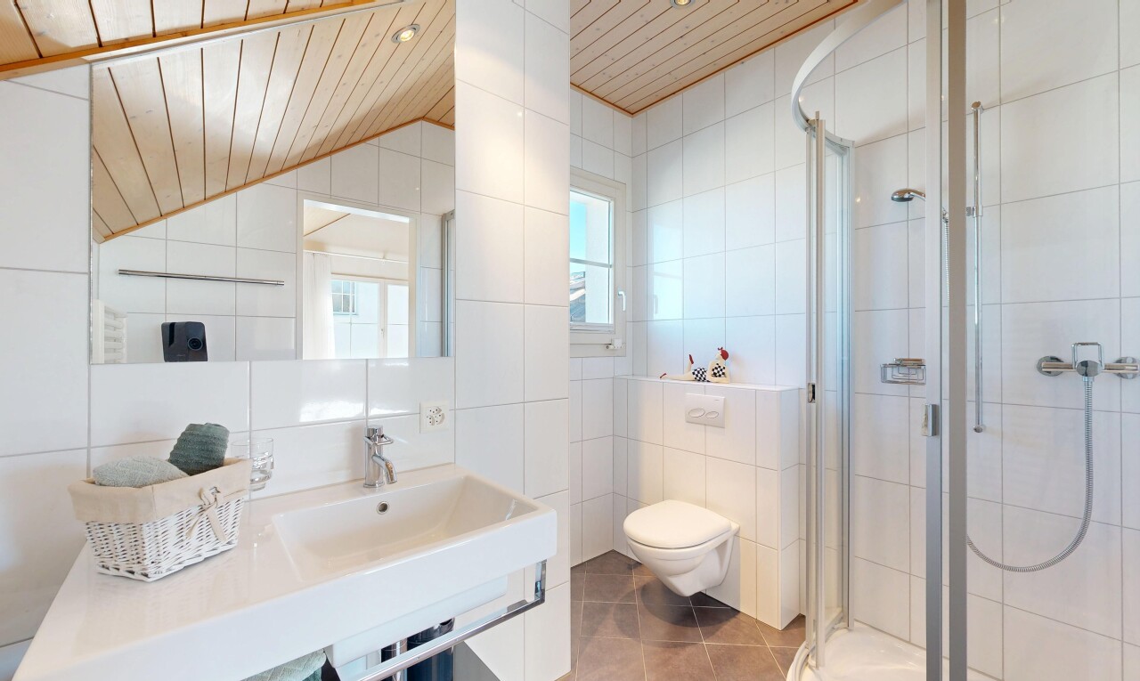 full bathroom featuring tile walls, a stall shower, and light tile patterned floors