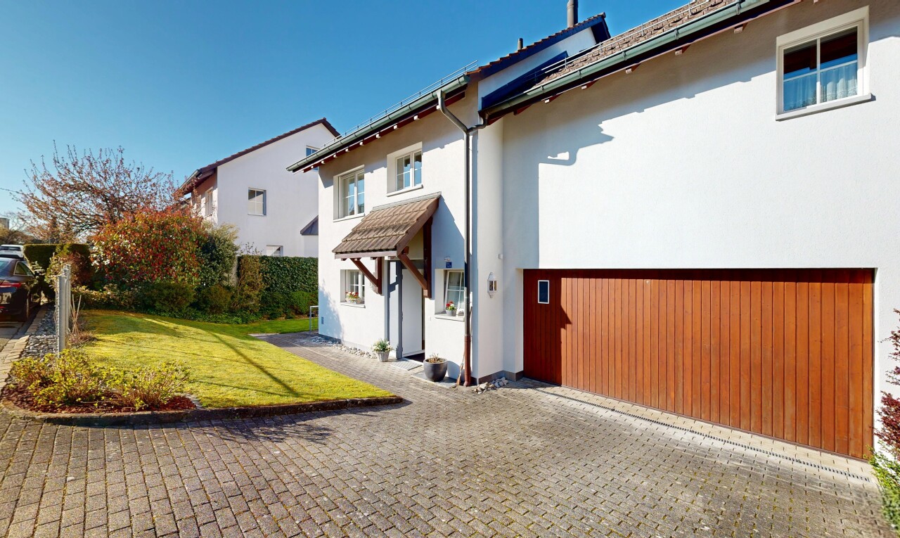 outdoor house with a yard and stucco siding