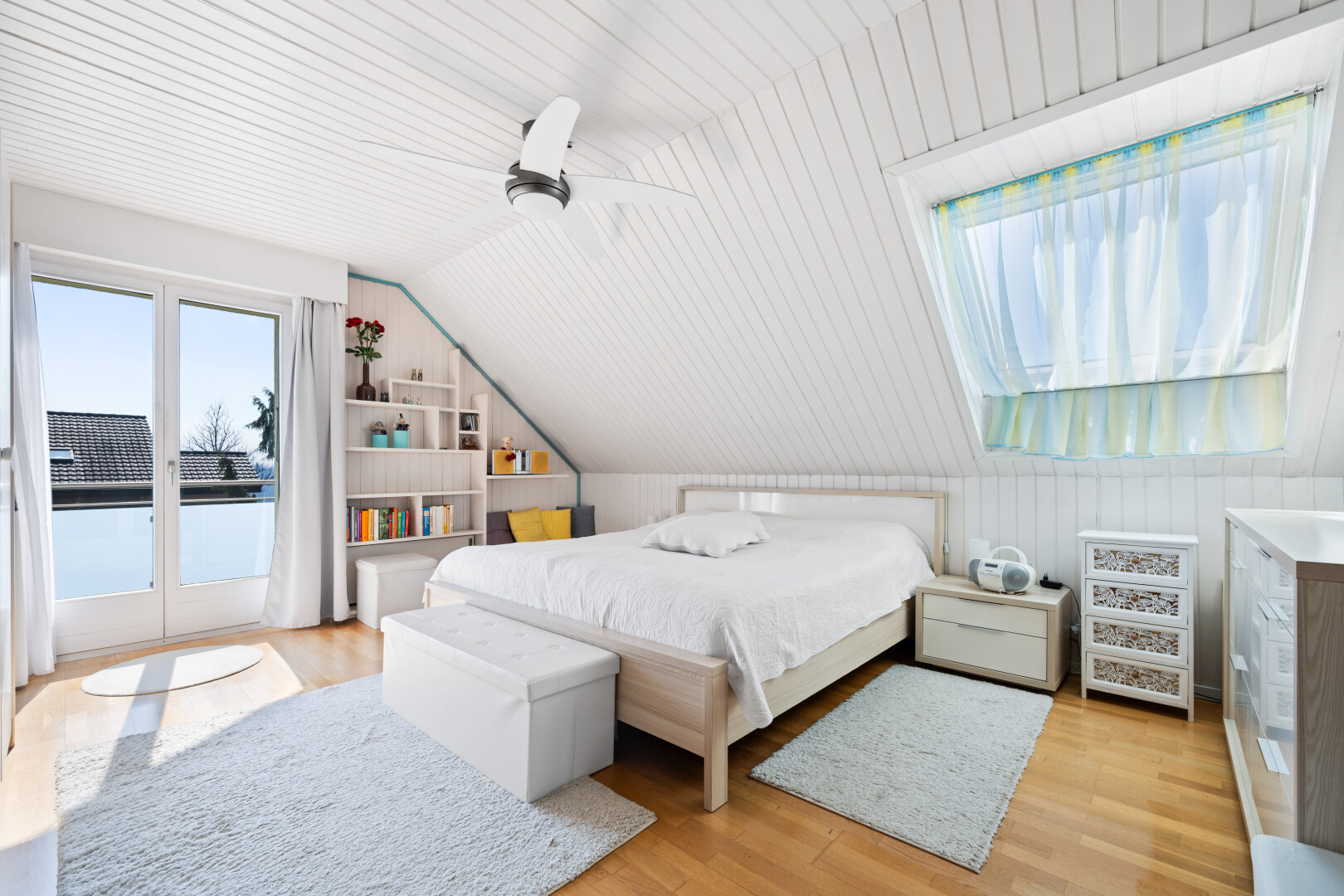 room with light wood finished floors, access to outside, vaulted ceiling, and ceiling fan