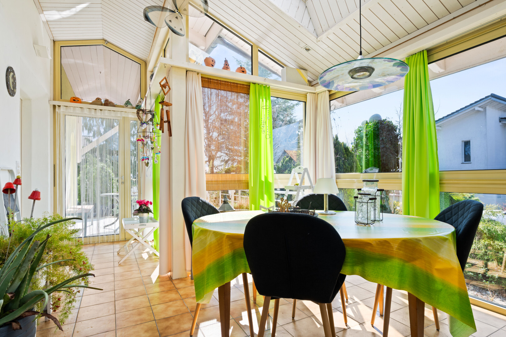 tiled dining space with healthy amount of natural light and a vaulted wooden ceiling