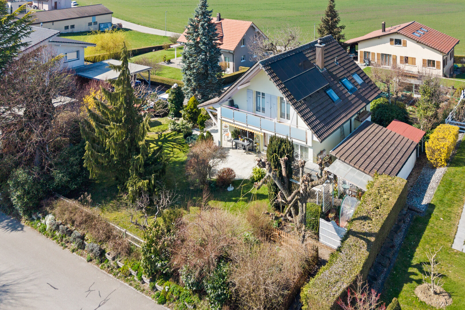 view of home featuring a balcony and solar panels