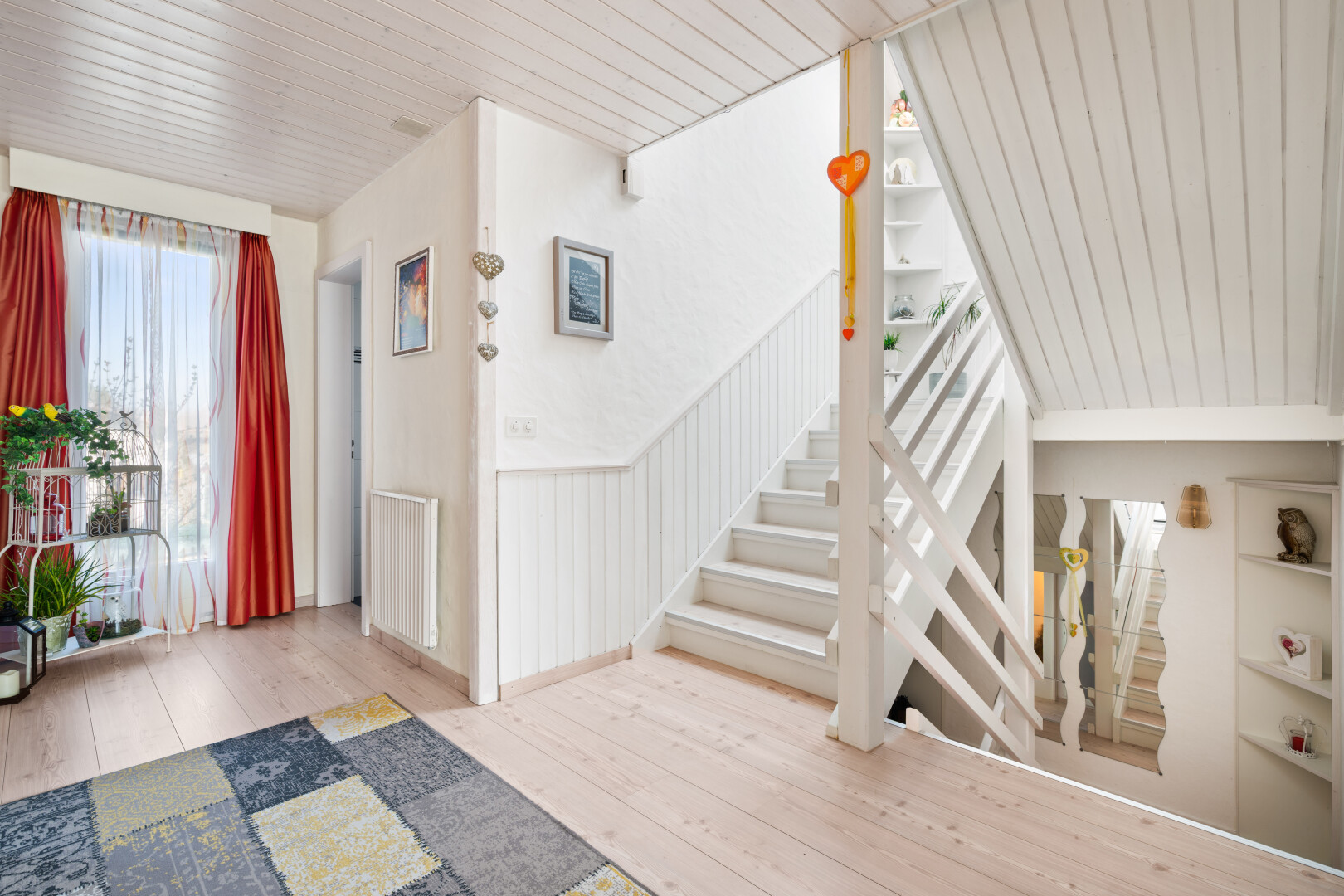 stairs with hardwood / wood-style flooring, wooden ceiling, and radiator