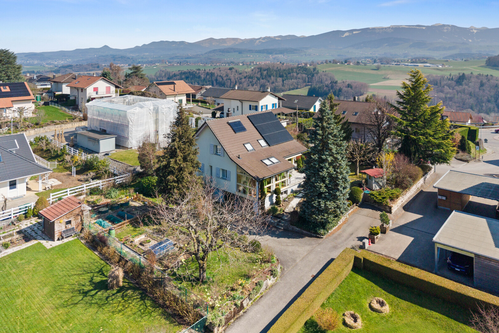 view of building exterior featuring a residential view and a mountain view