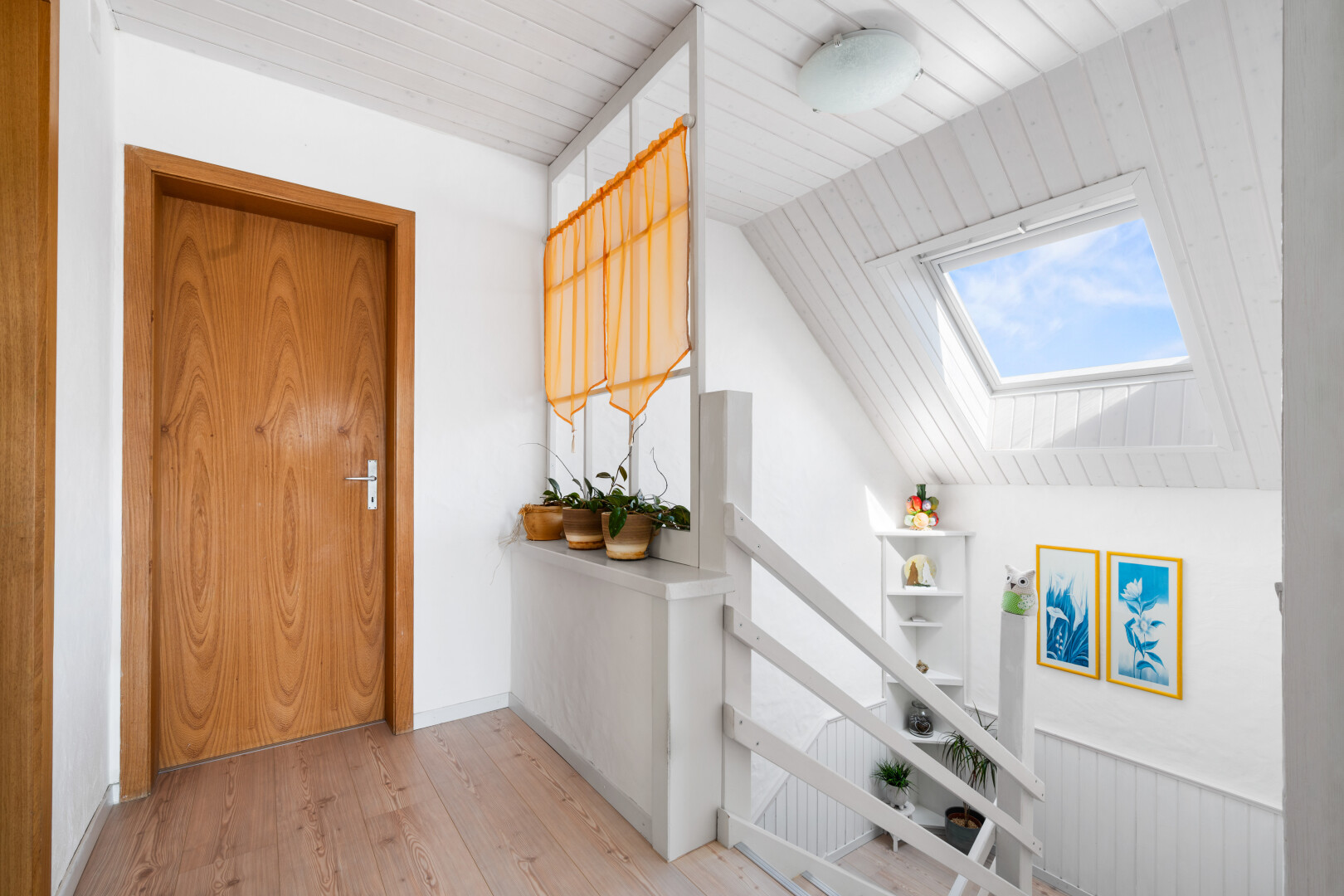 hall with a skylight, wood ceiling, and light wood-type flooring