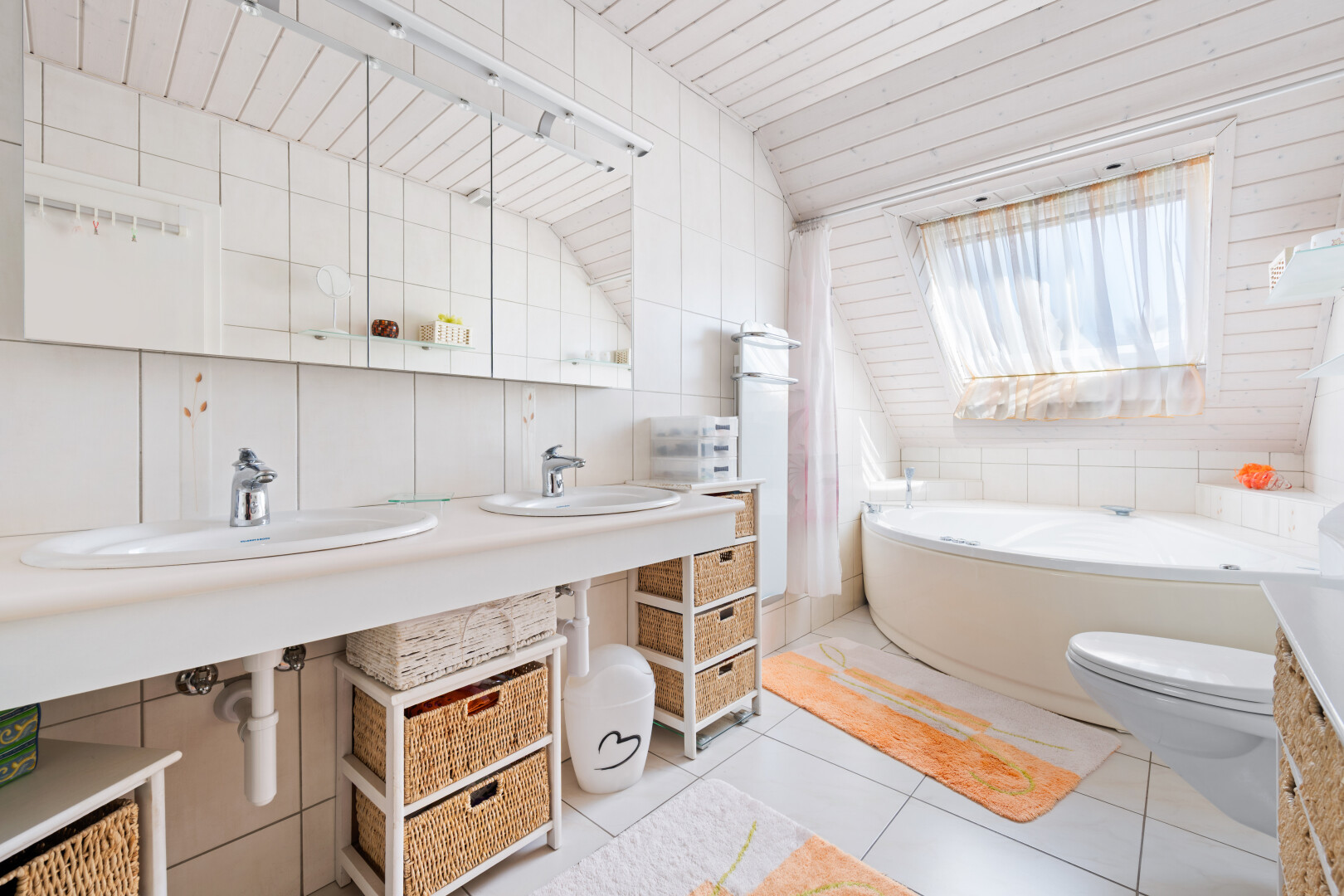 full bathroom with double vanity, tile walls, a bath, and light tile patterned floors