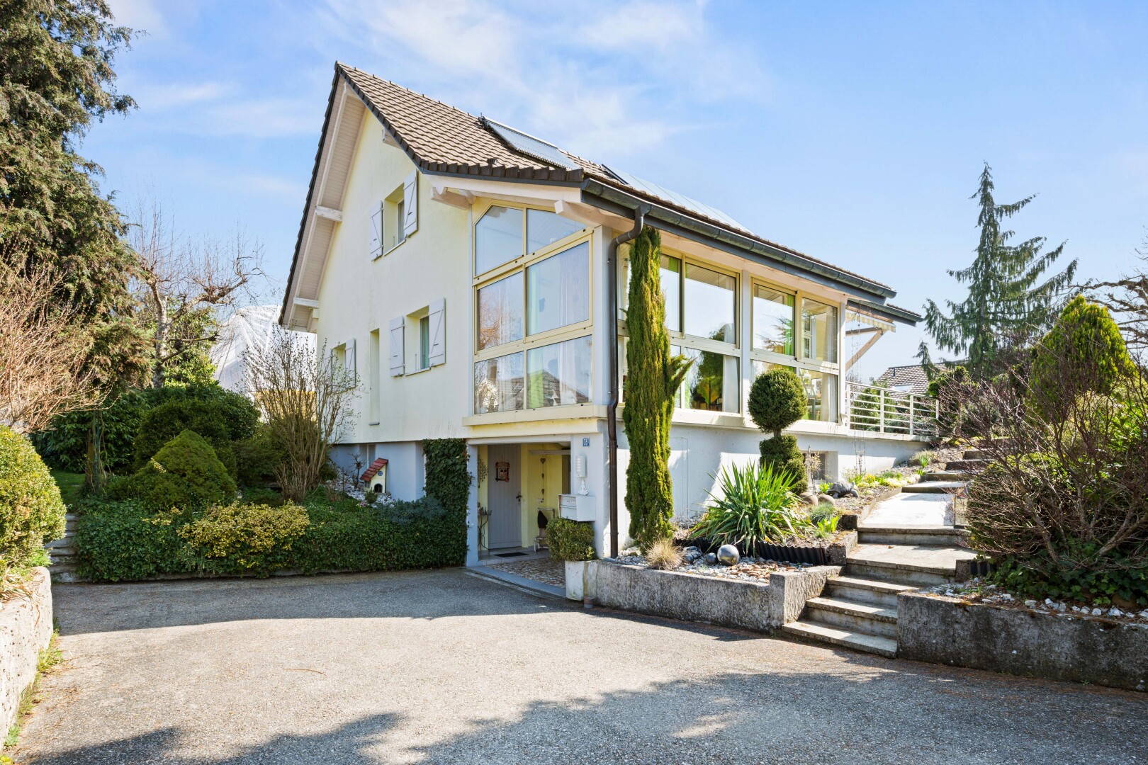view of home with stucco siding and roof mounted solar panels