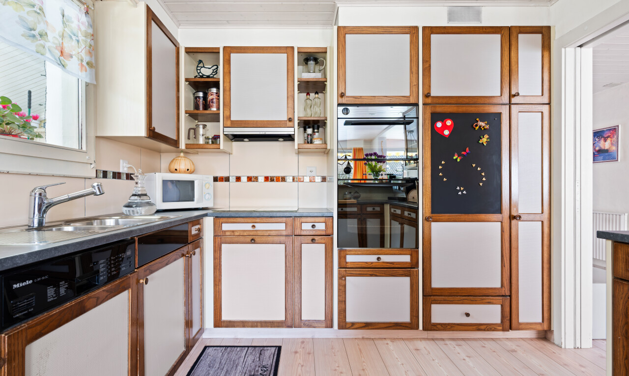 cuisine avec light floor, inside property, lave-vaisselle, sol en finition bois, et wood finish floor