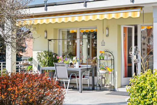 view of home featuring stucco siding and outdoor dining area