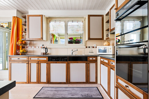 two tone kitchen with two tone cabinets, plenty of natural light, open shelves, dark countertops, and wooden ceiling
