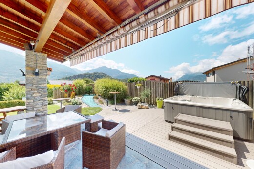 patio / terrace with a hot tub, a deck with mountain view, a fenced backyard, and outdoor dining area
