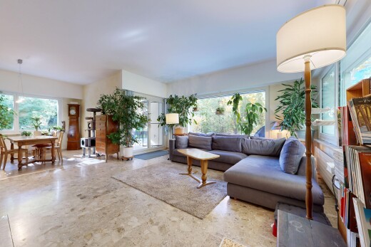 living / dining area featuring healthy amount of natural light, pendant lighting, and access to outside