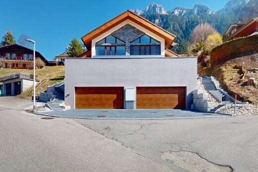 außenansicht mit stuckverkleidung, blick auf die berge, eingebaute garage, und auffahrt