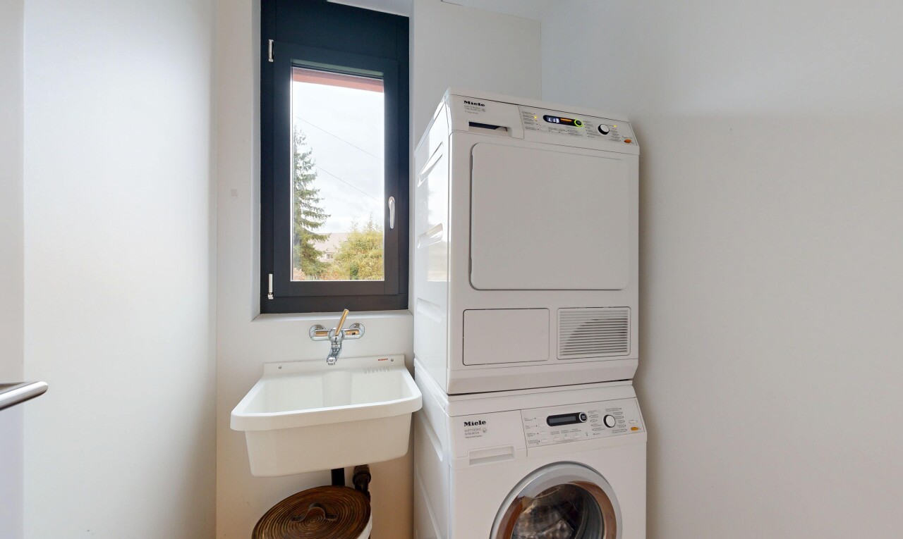 buanderie avec inside property, lave-linge et sèche-linge superposés, buanderie, drywall, et cloison sèche