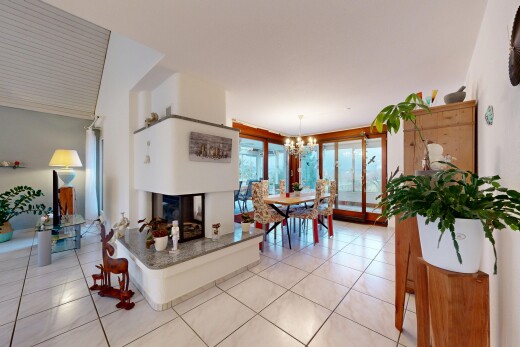 living room featuring light tile patterned floors, a multi sided fireplace, and a chandelier