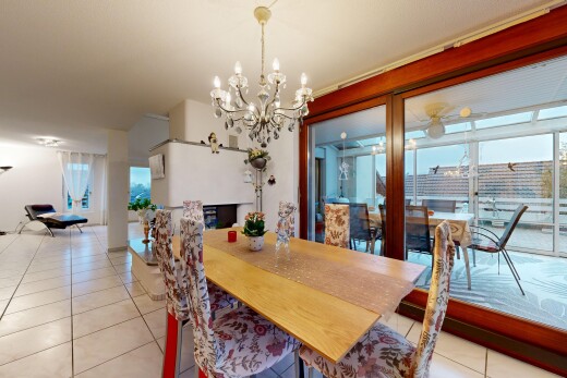 dining space featuring light tile patterned floors and a chandelier