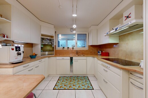 kitchen with open shelves, light countertops, white cabinets, oven, and light tile patterned floors