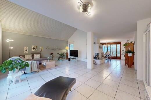 living room with vaulted ceiling, light tile patterned floors, and a chandelier