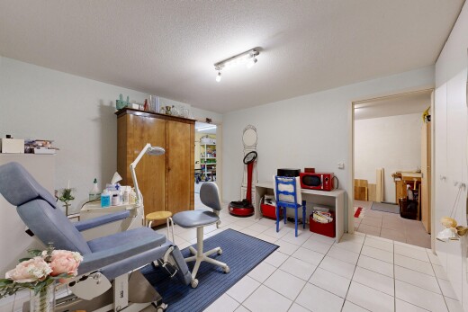 exercise room featuring light tile patterned floors and a textured ceiling