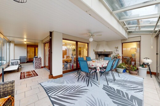 dining room with an outdoor brick fireplace, a ceiling fan, light tile patterned floors, and a sunroom