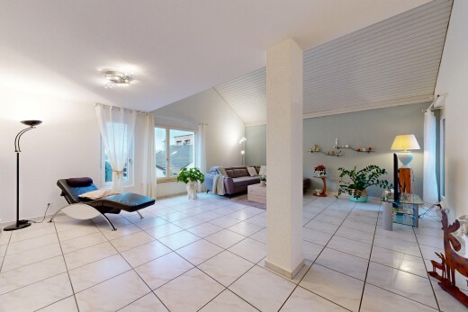 living room with light tile patterned flooring and vaulted ceiling