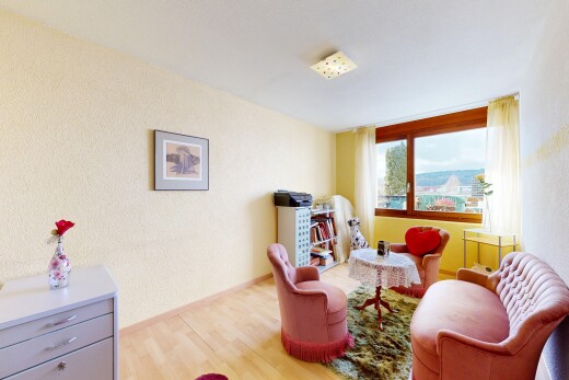 living room featuring a textured wall and light wood-type flooring