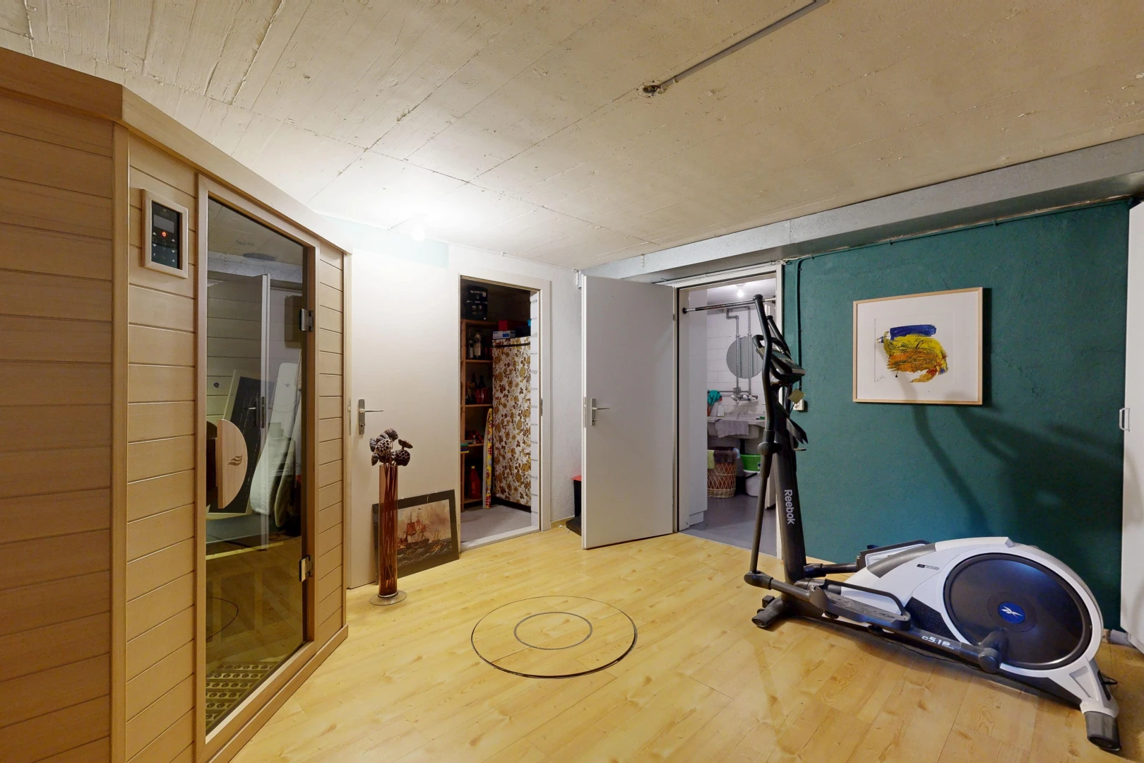 gym avec sous-sol, low ceiling, plafond bas, wood finish floor, et sol en finition bois