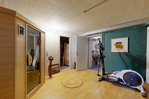gym avec sous-sol, low ceiling, plafond bas, wood finish floor, et sol en finition bois