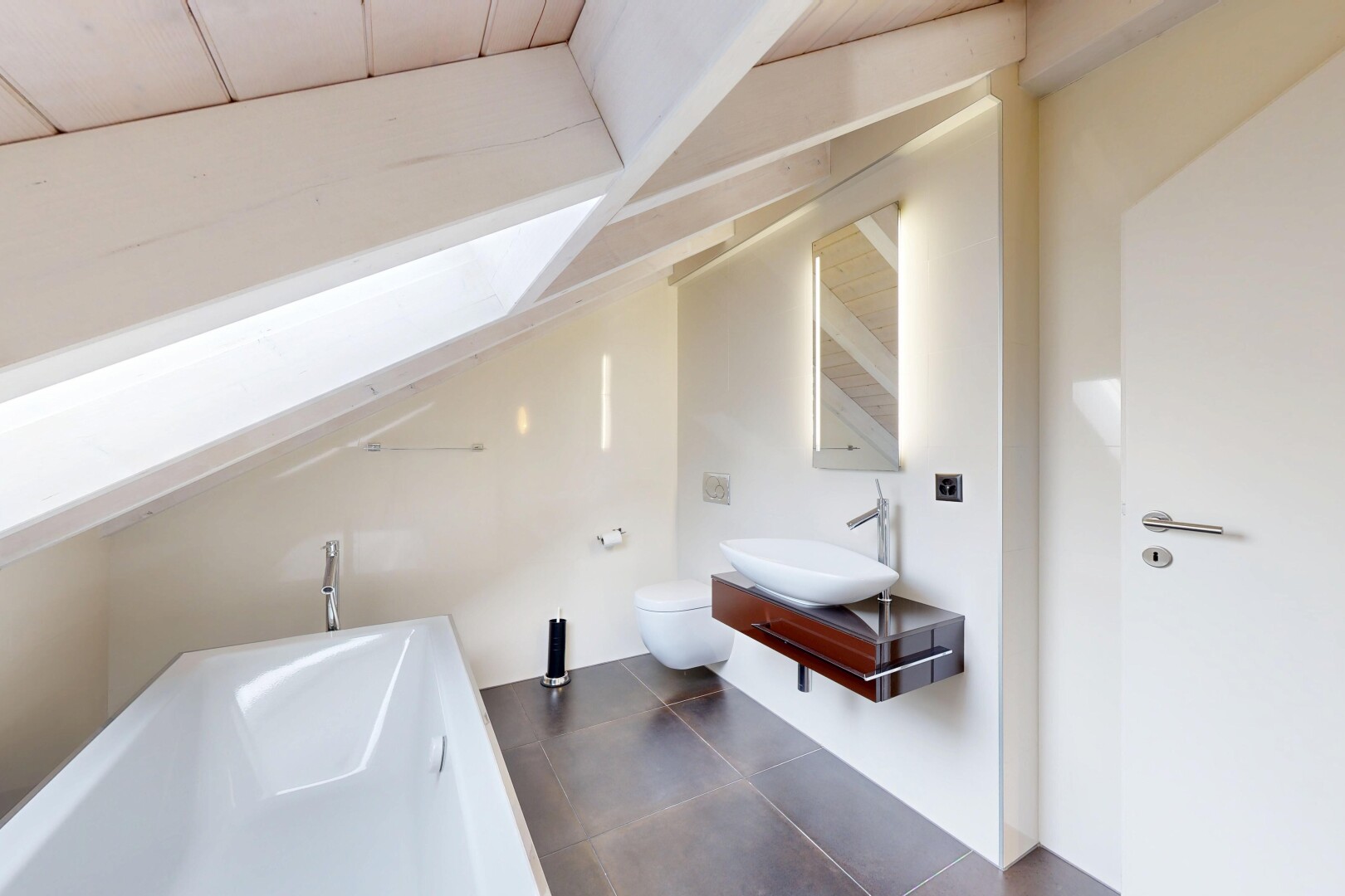 bathroom featuring a bath, vanity, vaulted ceiling, and dark tile patterned flooring