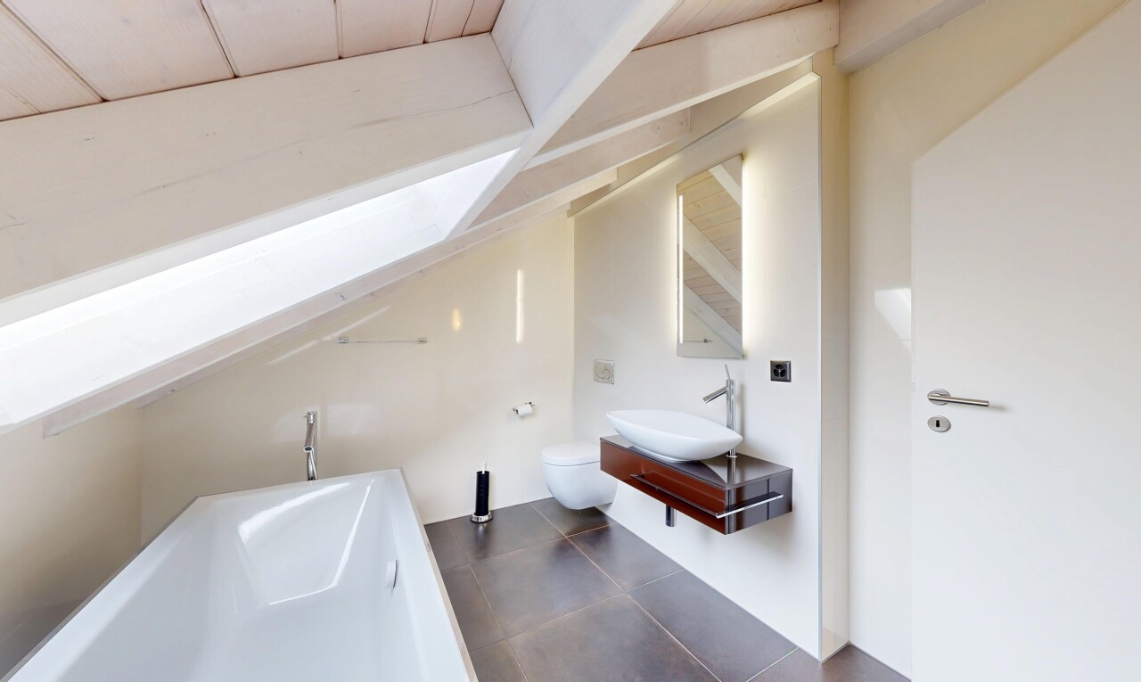 bathroom featuring a bath, vanity, vaulted ceiling, and dark tile patterned flooring