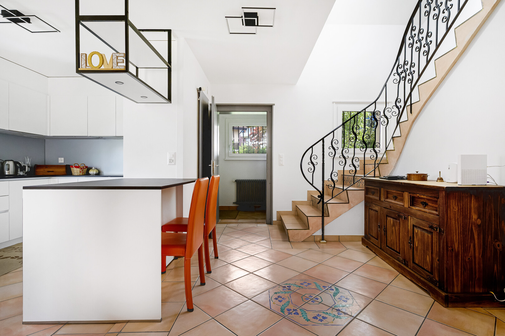 dining room featuring stairs, light tile patterned floors, and radiator heating unit