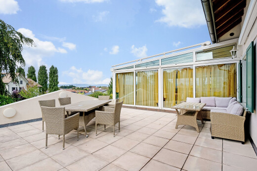 terrace with outdoor dining area, a patio area, and a sunroom