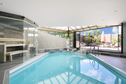 indoor pool with a patio area and a sunroom