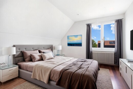 room / bedroom with dark wood-style floors, vaulted ceiling, radiator heating unit, and an office area
