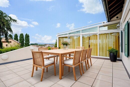 terrace with outdoor dining area, a patio area, and a sunroom