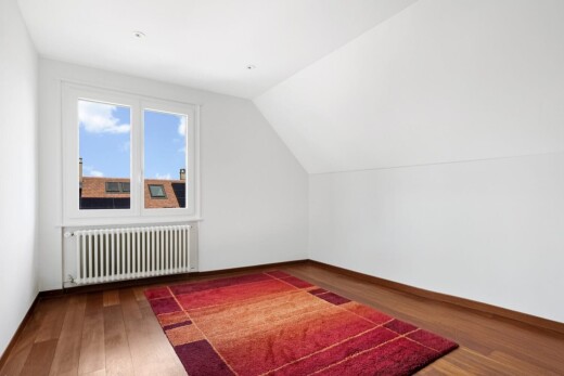 spare room featuring radiator heating unit, vaulted ceiling, and dark wood-type flooring